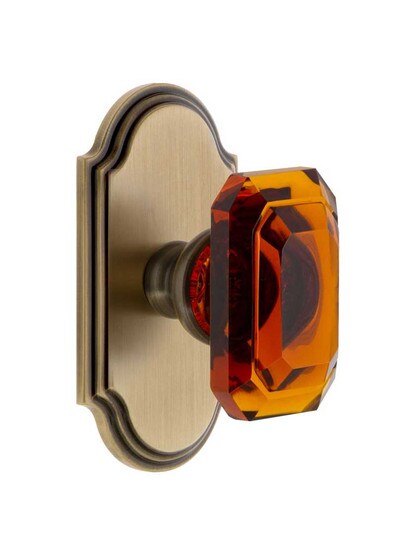 Grandeur Arc Rosette Door Set with Amber Crystal-Glass Baguette Knobs in Antique Brass.